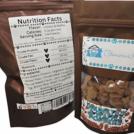 Nutrition Facts label on a bag of Drumstick & Waffle Poppers Dog Treats by Glamorous Pups. This label details the ingredients and nutritional values, including 5 calories per treat and a serving size of 3 to 5 pieces for a 50lb dog. The packaging, shown partially, features a glossy brown finish with a transparent section revealing the unique drumstick and waffle shaped treats, branded with the Glamorous Pups logo. Highlights include all-natural ingredients and sustainable, made in the USA production.