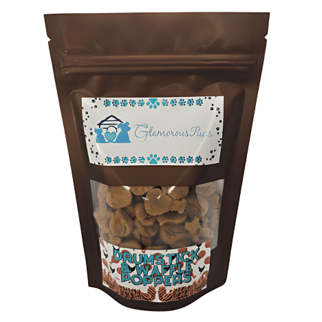 8oz bag of Drumstick & Waffle Poppers Dog Treats by Glamorous Pups, in a glossy brown package with a clear window displaying uniquely shaped treats. The label features the Glamorous Pups logo and the product name, highlighting these gourmet, made-in-the-USA dog treats.