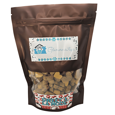 Packaging of Sweet À La Mode Dog Treats by Glamorous Pups, 1lb bag. The bag features a clear window displaying heart and bone-shaped treats, with a vibrant red and white label reading 'Sweet À La Mode'. Above, the Glamorous Pups logo is surrounded by blue and teal paw prints, emphasizing the brand's commitment to quality and natural ingredients. Ideal for pet owners searching for premium, all-natural treats made in the USA.