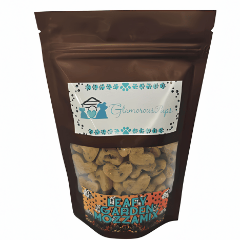 Packaged in an attractive brown pouch, the Leafy Garden MozzaMix Dog Treats by Glamorous Pups prominently display their natural and healthy treats through a clear window. The front label is adorned with a stylish logo and decorative teal and blue motifs, emphasizing the high-quality, spinach, kale, and mozzarella-infused treats ideal for health-conscious pet owners.