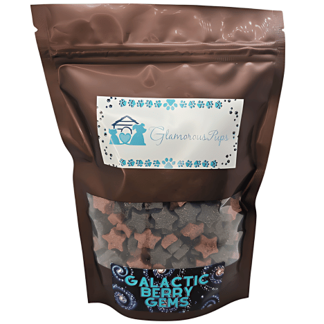 1 lb packaging of Galactic Berry Gems Dog Treats by Glamorous Pups, featuring a modern, cosmic-themed design with star and nebula motifs. The transparent viewing window showcases the mixed berry-colored, star-shaped treats inside, emphasizing their premium quality and enticing visual appeal. Ideal for pet lovers looking for nutritious and visually appealing treats for their canine companions.