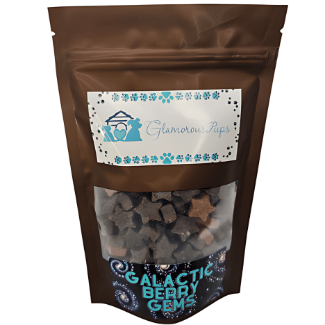 8 oz packaging of Galactic Berry Gems Dog Treats by Glamorous Pups, prominently displaying a sleek, space-themed design. The bag features starry accents and a transparent window revealing the uniquely shaped, star and gem-like treats inside, showcasing their quality and hinting at their irresistible berry flavor. Perfect for pet owners seeking high-quality, themed snacks for their dogs.