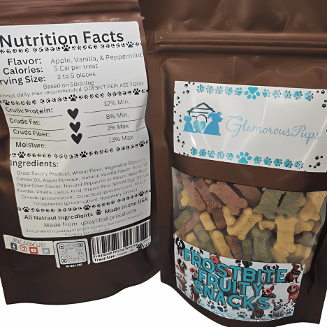 Photo of a bag of Frostbite Fruity Snacks Dog Treats by Glamorous Pups. The bag features a nutrition facts label detailing the flavors—Apple, Vanilla, and Peppermint—and comprehensive ingredient information, highlighting their natural and health-focused composition. These dog treats are designed for pet owners looking for all-natural, delicious treat options for their pets.