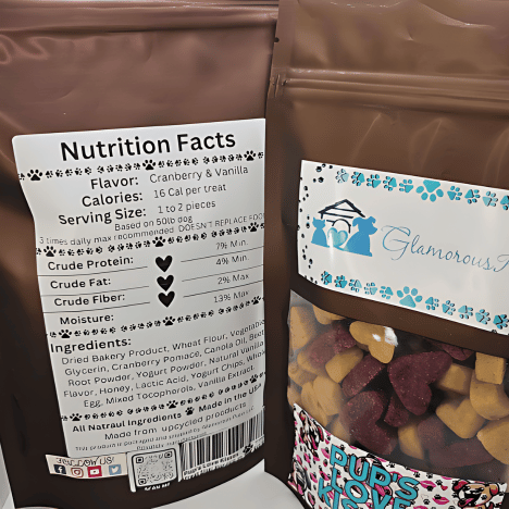 Nutrition facts label and product display for Pup's Love Kisses Dog Treats by Glamorous Pups, highlighting key details like flavor, ingredients, and calorie count on a brown packaging bag, emphasizing its cranberry & oat flavor and natural ingredients.