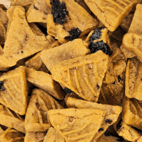 Detailed view of Blueberry Pupcake Party treats by Glamorous Pups, piled closely to showcase their unique pancake shape and texture, with visible dark blueberry chunks. These all-natural, high-quality dog treats exemplify healthy snacking with their rich fruit content, catering to pet owners who prefer nutritious, tasty, and responsibly produced pet products from the USA.