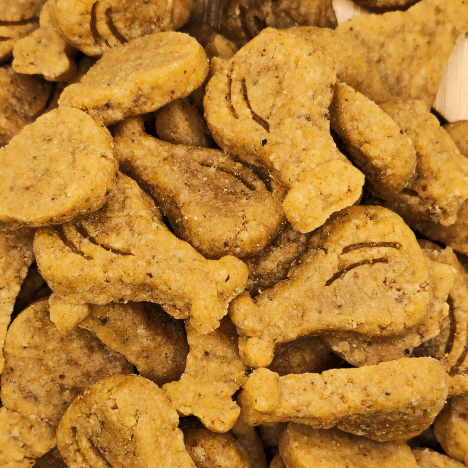 Dense pile of Drumstick & Waffle Poppers Dog Treats by Glamorous Pups, displayed to highlight their distinctive shapes resembling drumsticks and waffles. The treats feature a textured, golden-brown surface, indicating their wholesome composition. These innovative and all-natural treats are designed for dog owners seeking fun and healthy snack options, meticulously crafted in the USA by Glamorous Pups.