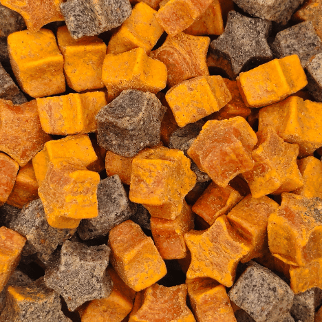 Highly detailed image of Cosmic Pupkin Berry Dog Treats by Glamorous Pups, featuring close-up views of uniquely shaped star and cube treats in rich pumpkin orange and deep berry hues. These all-natural, USA-made dog treats are perfect for pets, combining tasty flavors with a commitment to quality and nutrition.