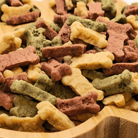 Zoomed-in view of Frostbite Fruity Snacks Dog Treats by Glamorous Pups, highlighting the multi-colored bone and star-shaped treats with flavors like apple, vanilla, and peppermint, designed to delight any dog's taste buds.