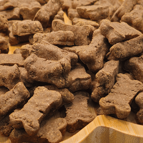 Close-up of Savory Bacon Bliss Dog Treats by Glamorous Pups, showcasing the detailed texture and bone shapes of these gourmet bacon-flavored treats, perfectly tailored for dog satisfaction and enjoyment.