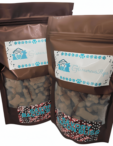 Assorted sizes of Savory Bacon Bliss Dog Treats by Glamorous Pups in brown resealable bags, featuring a transparent viewing window that showcases heart-shaped treats. The design includes a distinctive blue and white logo of Glamorous Pups.