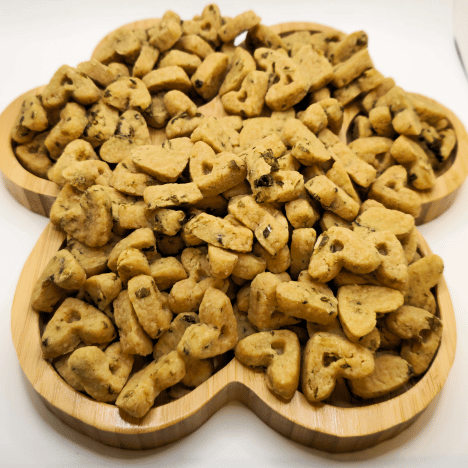 Wholesome Leafy Garden MozzaMix Dog Treats by Glamorous Pups, featuring a nutritious blend of leafy greens and mozzarella. This image showcases the unique bone-shaped treats arranged on a wooden paw-shaped board, emphasizing their all-natural ingredients tailored for health-conscious pet owners. Ideal for SEO focused on organic dog treats and premium pet food by Glamorous Pups.