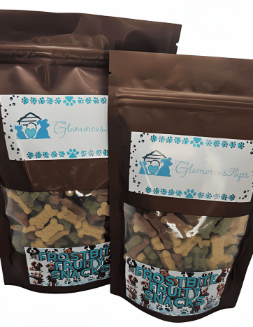 Image shows two bags of Frostbite Fruity Snacks Dog Treats by Glamorous Pups. The packaging is detailed with a clear viewing window to display the mixed-fruit shaped dog treats inside. These treats are perfect for pet owners seeking nutritious and delicious options for their dogs, enhancing treat time with quality and flavor.