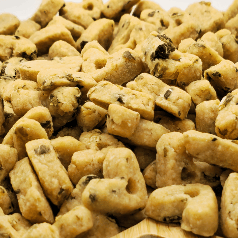 Zoomed-in view showcasing the unique texture of Leafy Garden MozzaMix Dog Treats by Glamorous Pups. These treats are shaped like small bones and packed with flavorful, natural ingredients like spinach, kale, and mozzarella. Perfect for SEO optimization targeting organic, wholesome pet treats available from Glamorous Pups.