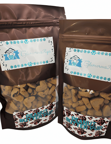 Image displaying 1lb and 8oz bags of Peanut Butter Pup Dog Treats from Glamorous Pups, prominently featuring the brand’s signature blue and white logo and a playful peanut-themed design on the packaging. The treats are visible through a clear viewing window, showcasing their unique shapes and emphasizing their appeal to dog owners looking for quality snacks.