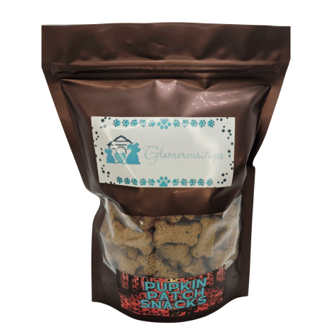 1lb bag of Pupkin Patch Snacks Dog Treats by Glamorous Pups featuring a transparent window to showcase the treats, adorned with a festive autumnal label, highlighting all-natural ingredients and crafted in the USA for quality assurance.