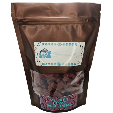 1lb bag of Velvet Love Whispers Dog Treats by Glamorous Pups, prominently displayed in a brown resealable package with a clear viewing window revealing heart-shaped red treats, labeled with the stylish Glamorous Pups branding.