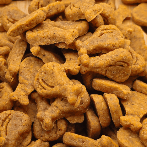 Zoomed-in view of Drumstick & Waffle Poppers Dog Treats by Glamorous Pups, showcasing an abundant stack of treats shaped like drumsticks and waffles. The detailed texture and golden brown color highlight the treats' all-natural ingredients, appealing to dog owners looking for creative and nutritious snack options. These treats are proudly made in the USA by Glamorous Pups, ensuring quality and satisfaction in every bite.