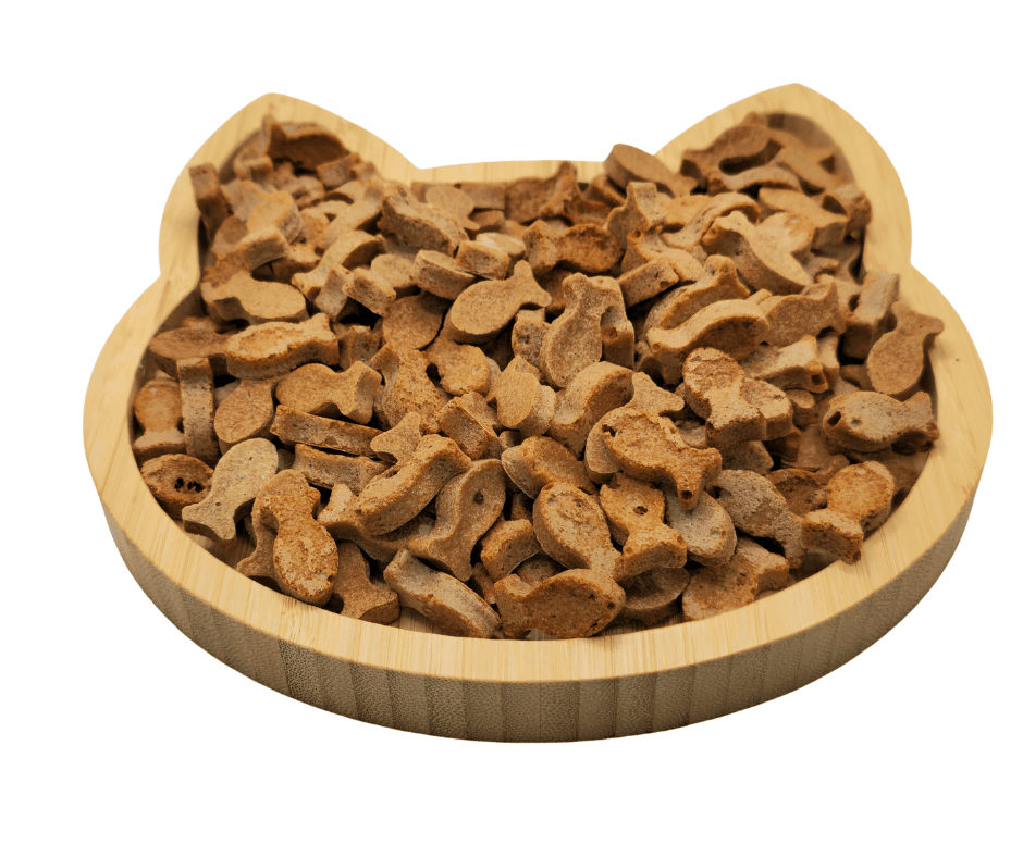 Ocean Purr-Fect Delights Cat Treats by Glamorous Pups, displayed in a cat-shaped wooden serving board, highlighting the unique fish forms and natural ingredients, perfect for feline indulgence and health.