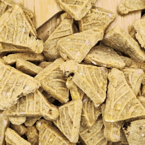 Zoomed-in view of Banana Bash Caps Dog Treats by Glamorous Pups, showcasing the textured surface and delicious banana chunks embedded within. These specially formulated dog treats from Glamorous Pups offer a delightful taste and texture that dogs love, emphasizing the brand's dedication to creating unique, high-quality pet treats